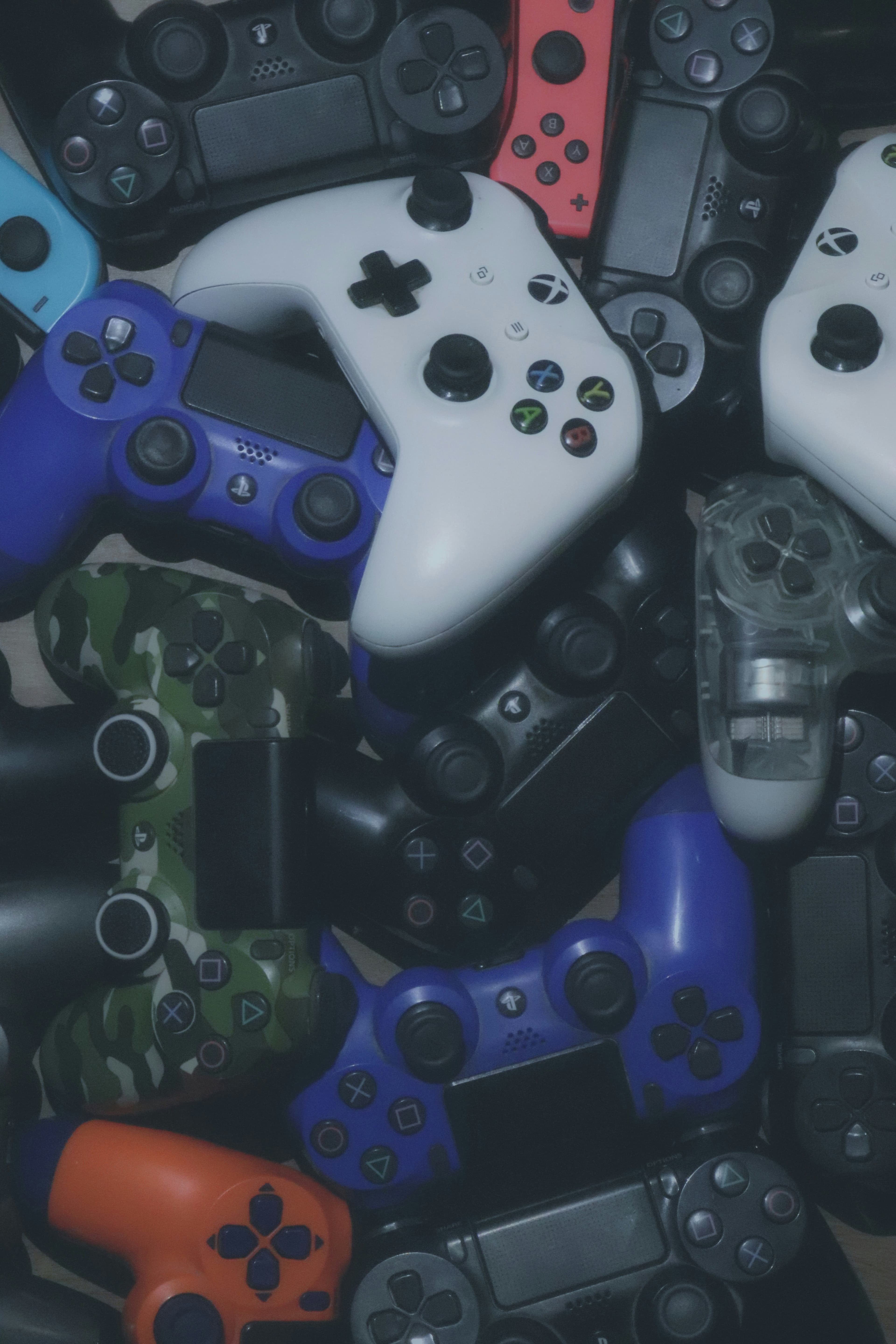 A pile of game controllers seen from above